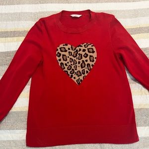Red sweater with leopard heart design.